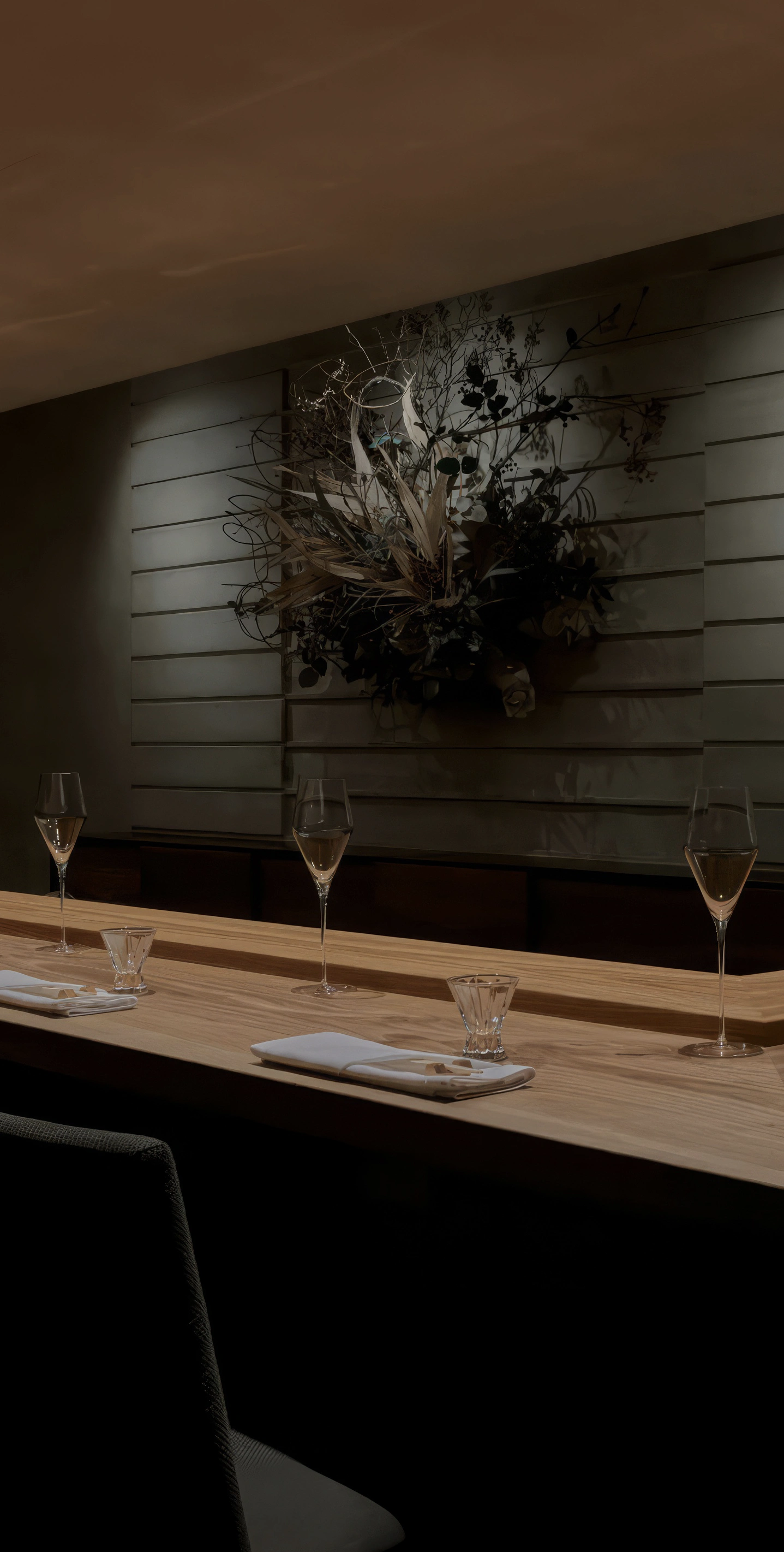 An image of the wooden sushi bar with minimalist design ready to serve guests at the restaurant ITO in New York City.