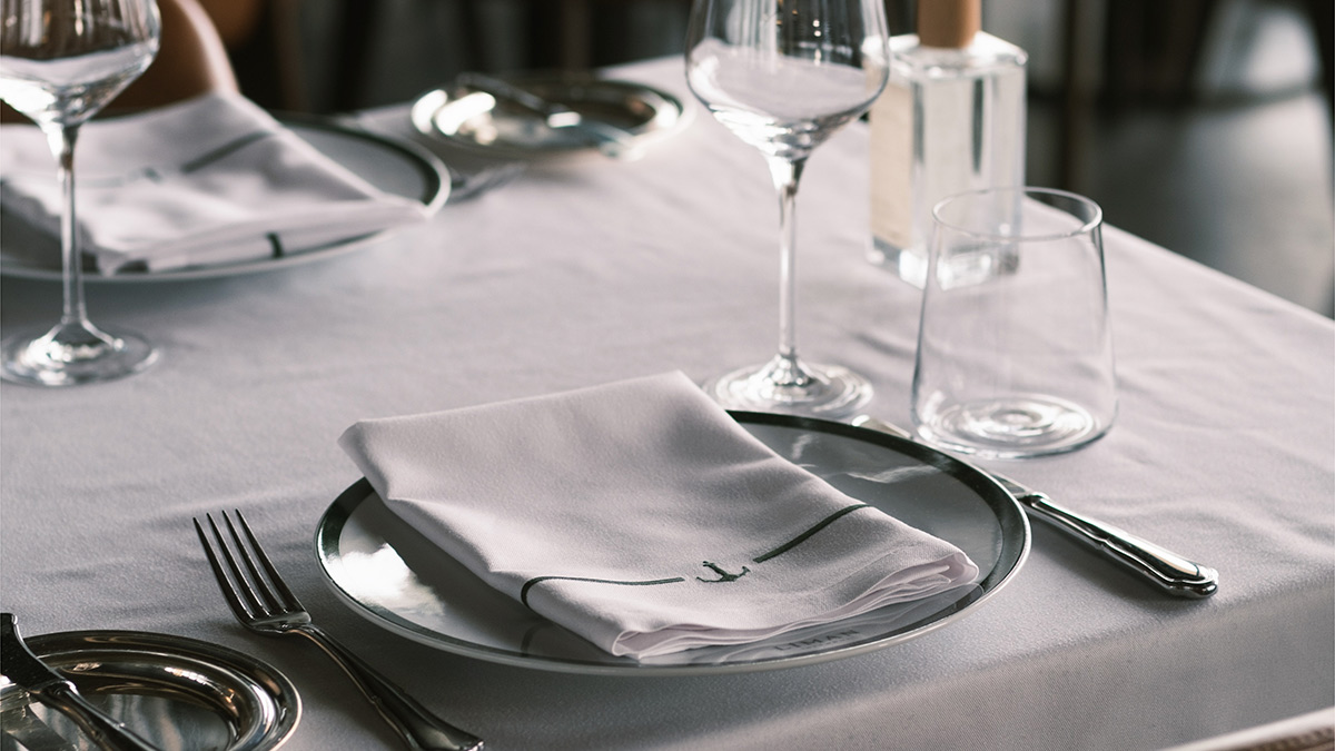 A close up picture of a table setting at a fancy restaurant